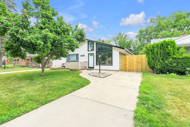 25288 Hopkins St, Dearborn Heights, MI 48125 - mid-century home with concrete driveway and a gate