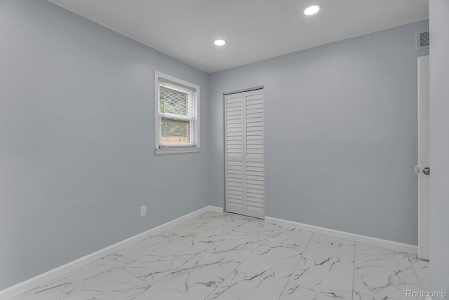 25288 Hopkins St, Dearborn Heights, MI 48125 - unfurnished bedroom featuring recessed lighting, light marble finish floors, and a closet
