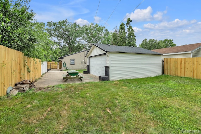 25288 Hopkins St, Dearborn Heights, MI 48125 - rear view of house with a fenced backyard, a patio area, a detached garage, and an outbuilding