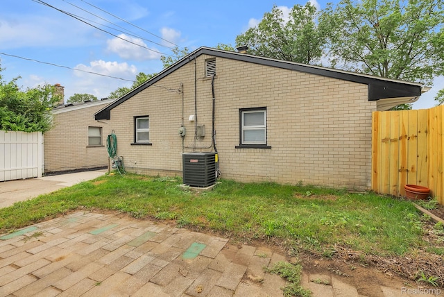 25288 Hopkins St, Dearborn Heights, MI 48125 - rear view of house with brick siding and a patio