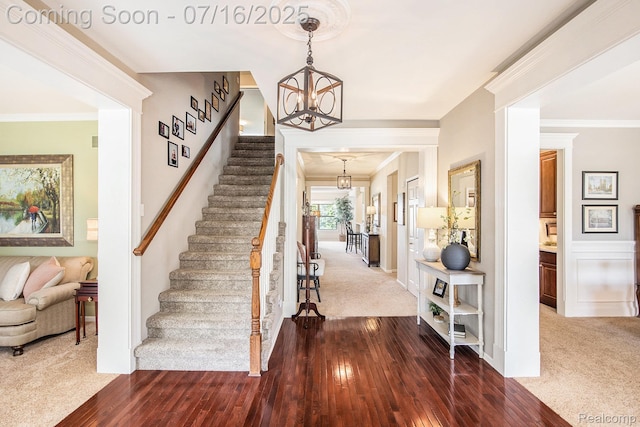 4190 Derry Ct, Oakland, MI 48306 - foyer entrance with a chandelier, stairway, hardwood / wood-style flooring, ornamental molding, and carpet