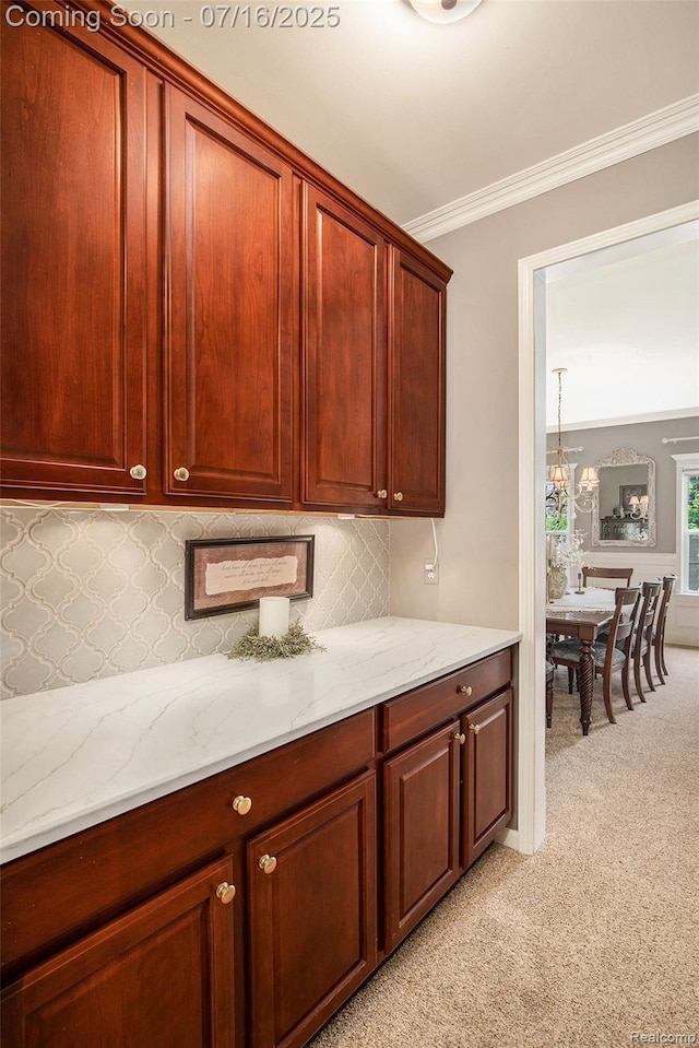 4190 Derry Ct, Oakland, MI 48306 - kitchen featuring light carpet, ornamental molding, decorative backsplash, light stone counters, and dark brown cabinets