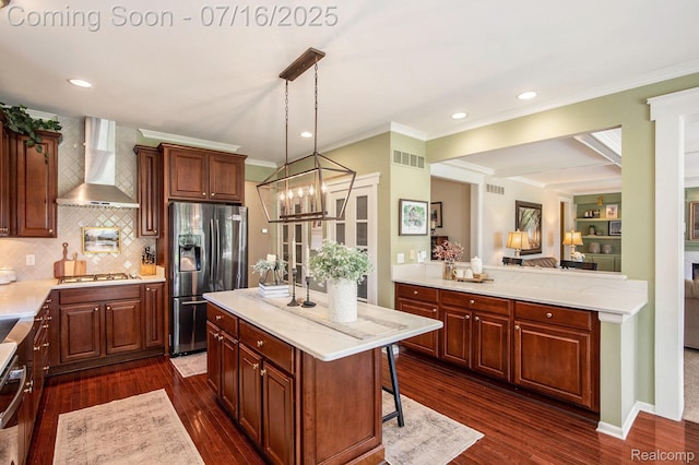 4190 Derry Ct, Oakland, MI 48306 - kitchen with wall chimney range hood, stainless steel appliances, ornamental molding, dark wood finished floors, and backsplash