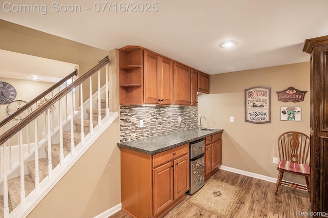 4190 Derry Ct, Oakland, MI 48306 - kitchen with light wood finished floors, backsplash, brown cabinets, dark countertops, and recessed lighting