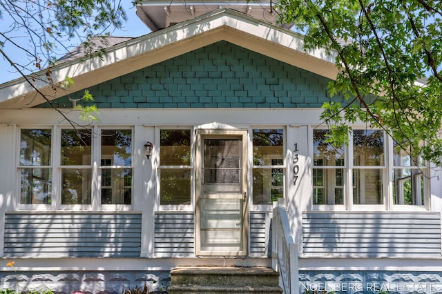 1307 Waverly Ave, Grand Haven, MI 49417 - view of exterior entry with roof with shingles