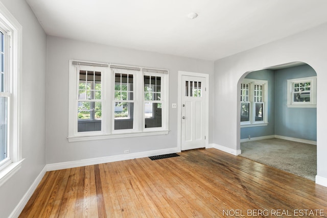 1307 Waverly Ave, Grand Haven, MI 49417 - foyer entrance with arched walkways and hardwood / wood-style floors
