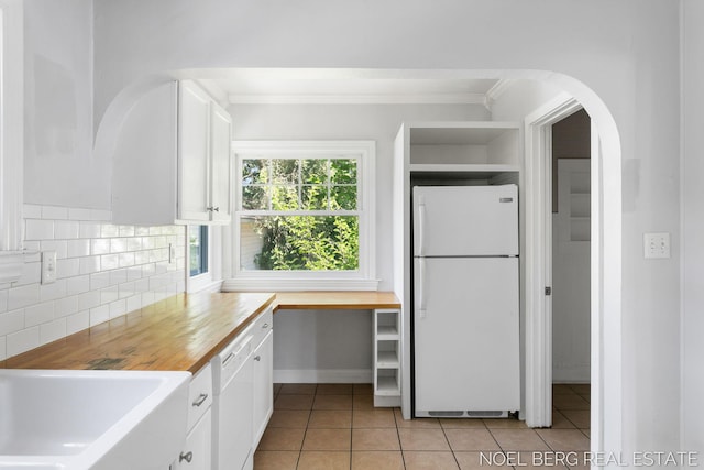 1307 Waverly Ave, Grand Haven, MI 49417 - kitchen with white appliances, white cabinetry, wood counters, ornamental molding, and light tile patterned flooring