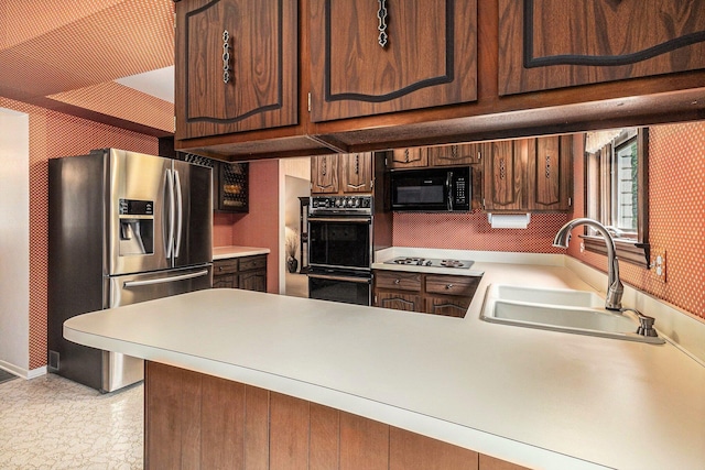 4213 Wentworth Dr, Troy, MI 48098 - kitchen with black appliances, wallpapered walls, light countertops, and a peninsula