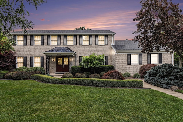 4213 Wentworth Dr, Troy, MI 48098 - colonial house featuring a front yard, brick siding, and a shingled roof