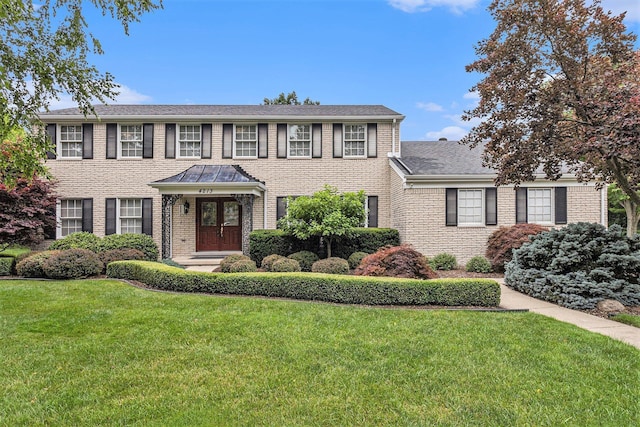 4213 Wentworth Dr, Troy, MI 48098 - colonial home featuring a front yard, brick siding, and roof with shingles