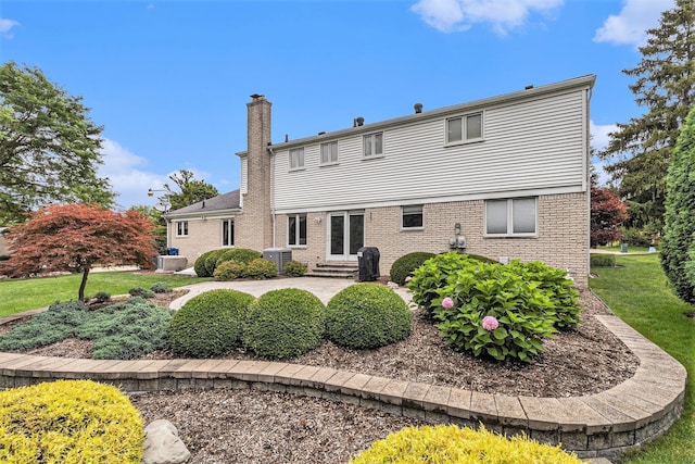 4213 Wentworth Dr, Troy, MI 48098 - rear view of house featuring a chimney, entry steps, a patio area, and brick siding