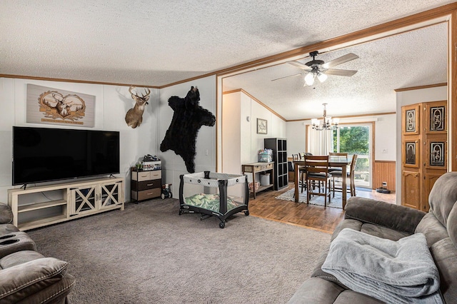 6671 E 136th St, Sand Lake, MI 49343 - living room with crown molding, a textured ceiling, a chandelier, a ceiling fan, and wainscoting