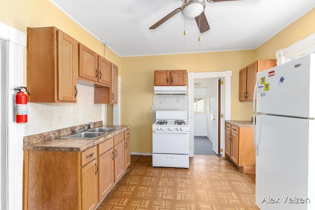 510 La Grave Ave SE, Grand Rapids, MI 49503 - kitchen featuring white appliances, under cabinet range hood, ceiling fan, and tasteful backsplash