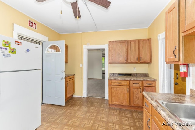 510 La Grave Ave SE, Grand Rapids, MI 49503 - kitchen with freestanding refrigerator, ceiling fan, and brown cabinetry