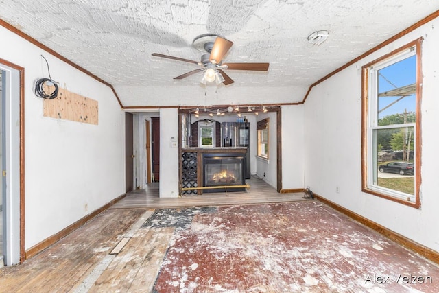 510 La Grave Ave SE, Grand Rapids, MI 49503 - unfurnished living room featuring ornamental molding, a glass covered fireplace, a ceiling fan, and wood finished floors