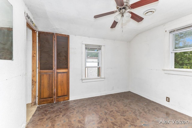 510 La Grave Ave SE, Grand Rapids, MI 49503 - unfurnished bedroom with multiple windows, lofted ceiling, and a ceiling fan