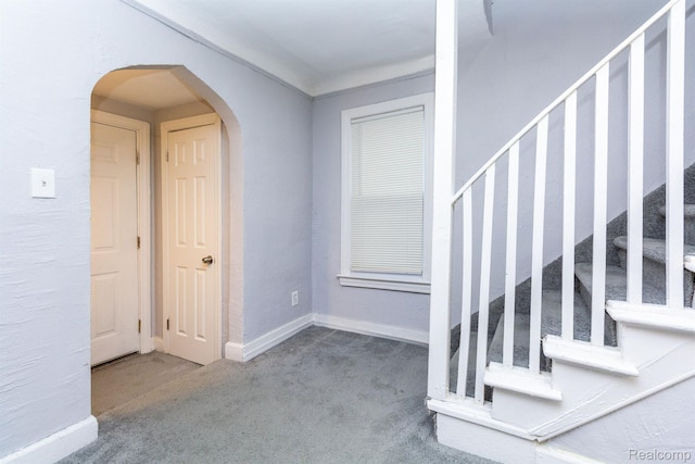 3602 Chatsworth St, Detroit, MI 48224 - carpeted foyer featuring stairway and arched walkways