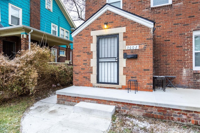 3602 Chatsworth St, Detroit, MI 48224 - view of exterior entry with brick siding and a chimney