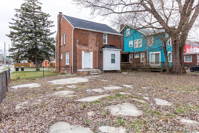 3602 Chatsworth St, Detroit, MI 48224 - rear view of property with a chimney and brick siding