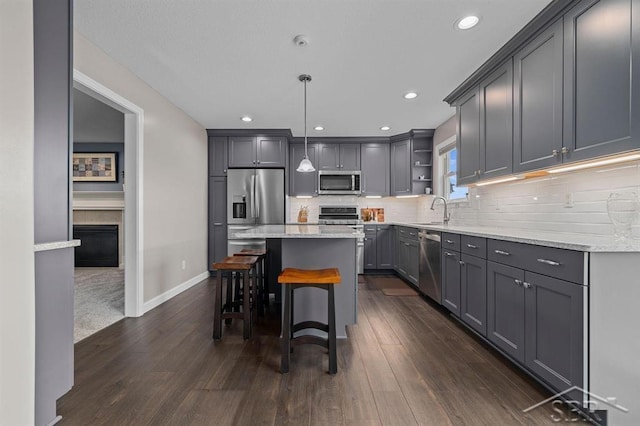 936 Appaloosa Pass, Auburn, MI 48611 - kitchen with appliances with stainless steel finishes, open shelves, a kitchen island, dark wood-style flooring, and recessed lighting