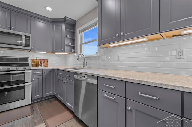936 Appaloosa Pass, Auburn, MI 48611 - kitchen featuring appliances with stainless steel finishes, gray cabinets, open shelves, tasteful backsplash, and recessed lighting
