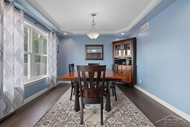 936 Appaloosa Pass, Auburn, MI 48611 - dining area featuring dark wood-type flooring, ornamental molding, a tray ceiling, and recessed lighting