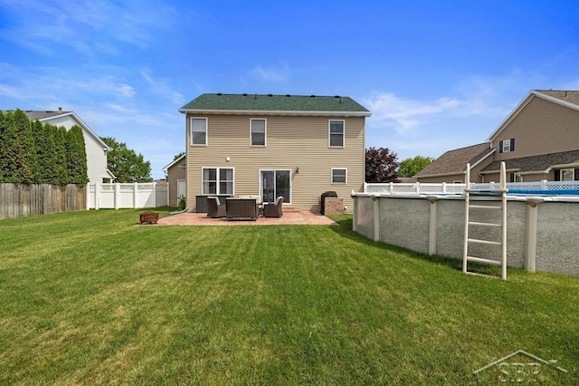 936 Appaloosa Pass, Auburn, MI 48611 - rear view of house with an outdoor hangout area and a patio