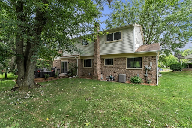 2840 Tuebingen Pkwy, Ann Arbor, MI 48105 - back of property featuring brick siding, a yard, and a wooden deck