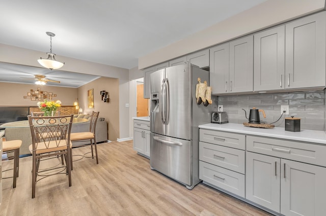 2840 Tuebingen Pkwy, Ann Arbor, MI 48105 - kitchen featuring stainless steel refrigerator with ice dispenser, gray cabinetry, light wood-type flooring, light countertops, and backsplash