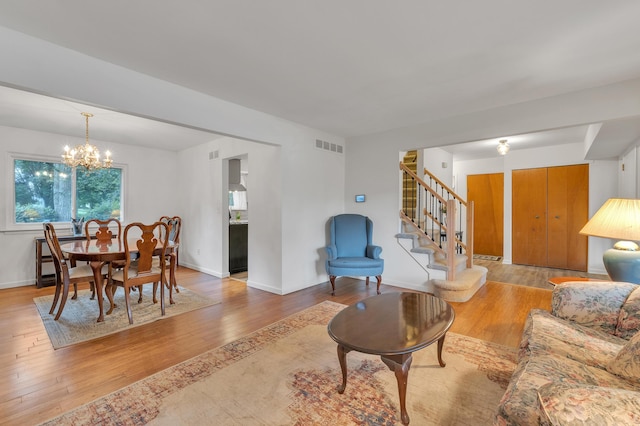 2840 Tuebingen Pkwy, Ann Arbor, MI 48105 - living area featuring stairway, a chandelier, and wood finished floors