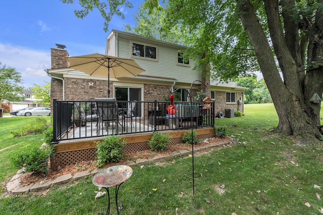 2840 Tuebingen Pkwy, Ann Arbor, MI 48105 - rear view of house with a chimney, a lawn, a wooden deck, and brick siding