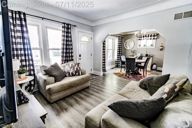 4168 Polk St, Dearborn Heights, MI 48125 - living area with arched walkways, a chandelier, and wood finished floors