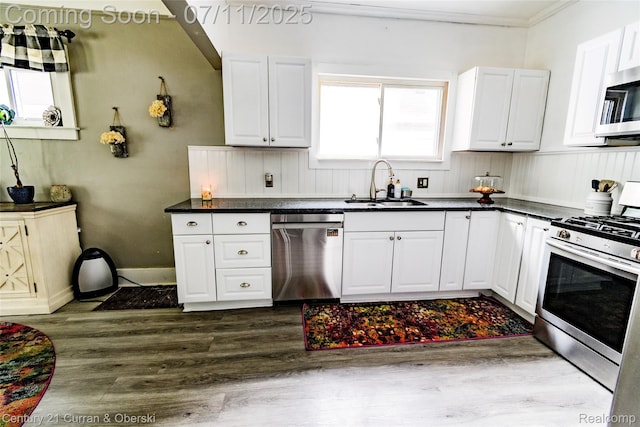 4168 Polk St, Dearborn Heights, MI 48125 - kitchen with appliances with stainless steel finishes, dark wood-type flooring, dark countertops, white cabinetry, and crown molding