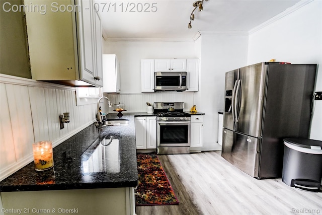 4168 Polk St, Dearborn Heights, MI 48125 - kitchen featuring stainless steel appliances, crown molding, light wood-type flooring, dark stone countertops, and a wainscoted wall