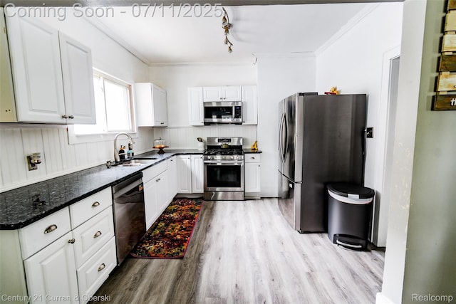 4168 Polk St, Dearborn Heights, MI 48125 - kitchen with appliances with stainless steel finishes, wood finished floors, white cabinets, ornamental molding, and dark stone counters