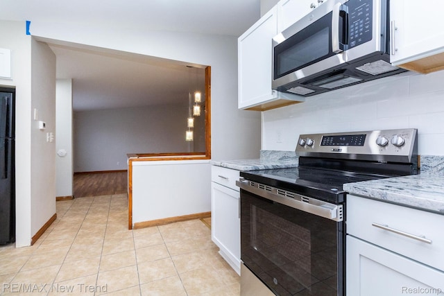 30604 Ann Arbor Trl, Westland, MI 48185 - kitchen with appliances with stainless steel finishes, backsplash, white cabinetry, and light stone countertops