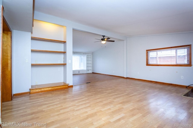 30604 Ann Arbor Trl, Westland, MI 48185 - unfurnished living room with plenty of natural light, a ceiling fan, built in features, light wood-style flooring, and lofted ceiling