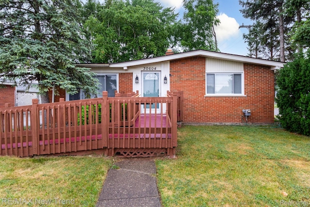 30604 Ann Arbor Trl, Westland, MI 48185 - ranch-style home with brick siding, a front yard, and a wooden deck