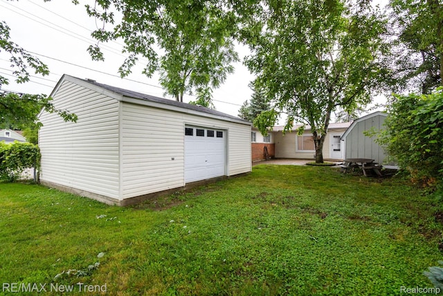 30604 Ann Arbor Trl, Westland, MI 48185 - view of green lawn featuring an outdoor structure and a garage