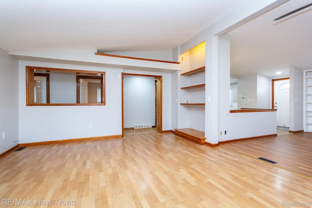 30604 Ann Arbor Trl, Westland, MI 48185 - unfurnished living room featuring built in features, wood finished floors, and vaulted ceiling