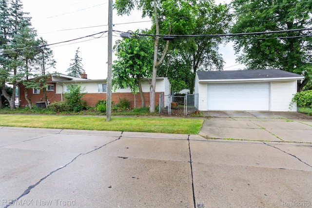 30604 Ann Arbor Trl, Westland, MI 48185 - view of front of house featuring a detached garage, a front yard, and brick siding