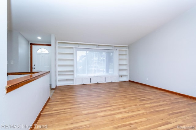 30604 Ann Arbor Trl, Westland, MI 48185 - unfurnished living room featuring built in features, light wood-style floors, and recessed lighting
