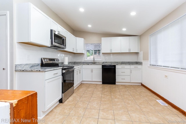 30604 Ann Arbor Trl, Westland, MI 48185 - kitchen with appliances with stainless steel finishes, white cabinets, light stone countertops, recessed lighting, and light tile patterned flooring