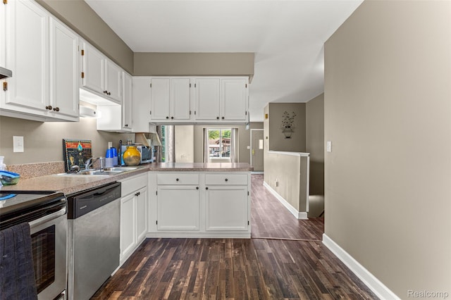 33050 Woodworth Ct, Westland, MI 48185 - kitchen featuring appliances with stainless steel finishes, dark wood-type flooring, white cabinetry, light countertops, and a peninsula