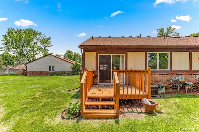 33050 Woodworth Ct, Westland, MI 48185 - back of house featuring a wooden deck, stucco siding, and a lawn