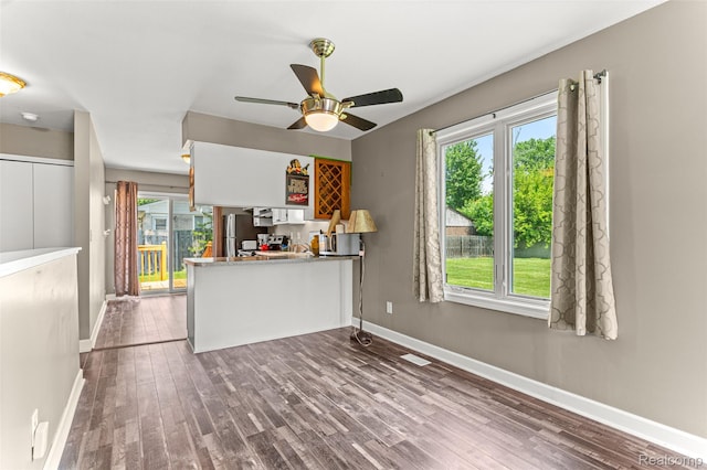 33050 Woodworth Ct, Westland, MI 48185 - kitchen featuring wood finished floors, ceiling fan, a peninsula, and freestanding refrigerator