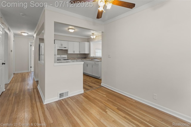 1681 Stieber St, Westland, MI 48186 - kitchen with white range with gas cooktop, under cabinet range hood, ceiling fan, light wood-style flooring, and ornamental molding