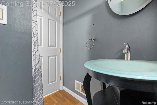 2900 Barton Dr, Sterling Heights, MI 48310 - bathroom featuring wood finished floors and baseboards