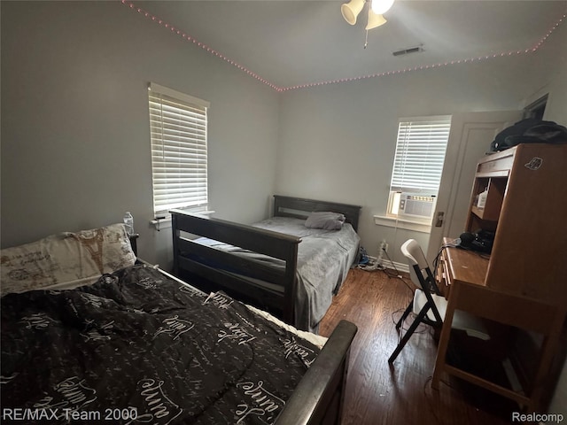 6815 Mettetal St, Detroit, MI 48228 - bedroom featuring wood finished floors, multiple windows, cooling unit, a ceiling fan, and vaulted ceiling