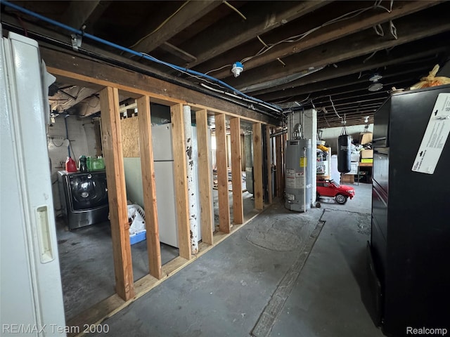 6815 Mettetal St, Detroit, MI 48228 - unfinished below grade area featuring gas water heater, washing machine and dryer, and freestanding refrigerator